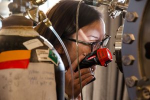 A student attending the Conference for Undergraduate Women in Physics (CUWiP) looks into the Frankestein’s Monster in the Aziz Lab, during a tour through the labs of the Harvard Science Center